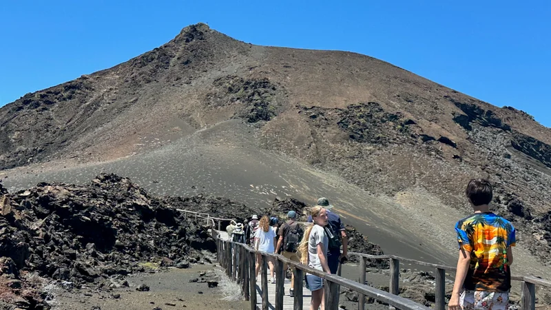 Visitors following the wooden trail across volcanic slopes on Bartolomé Island